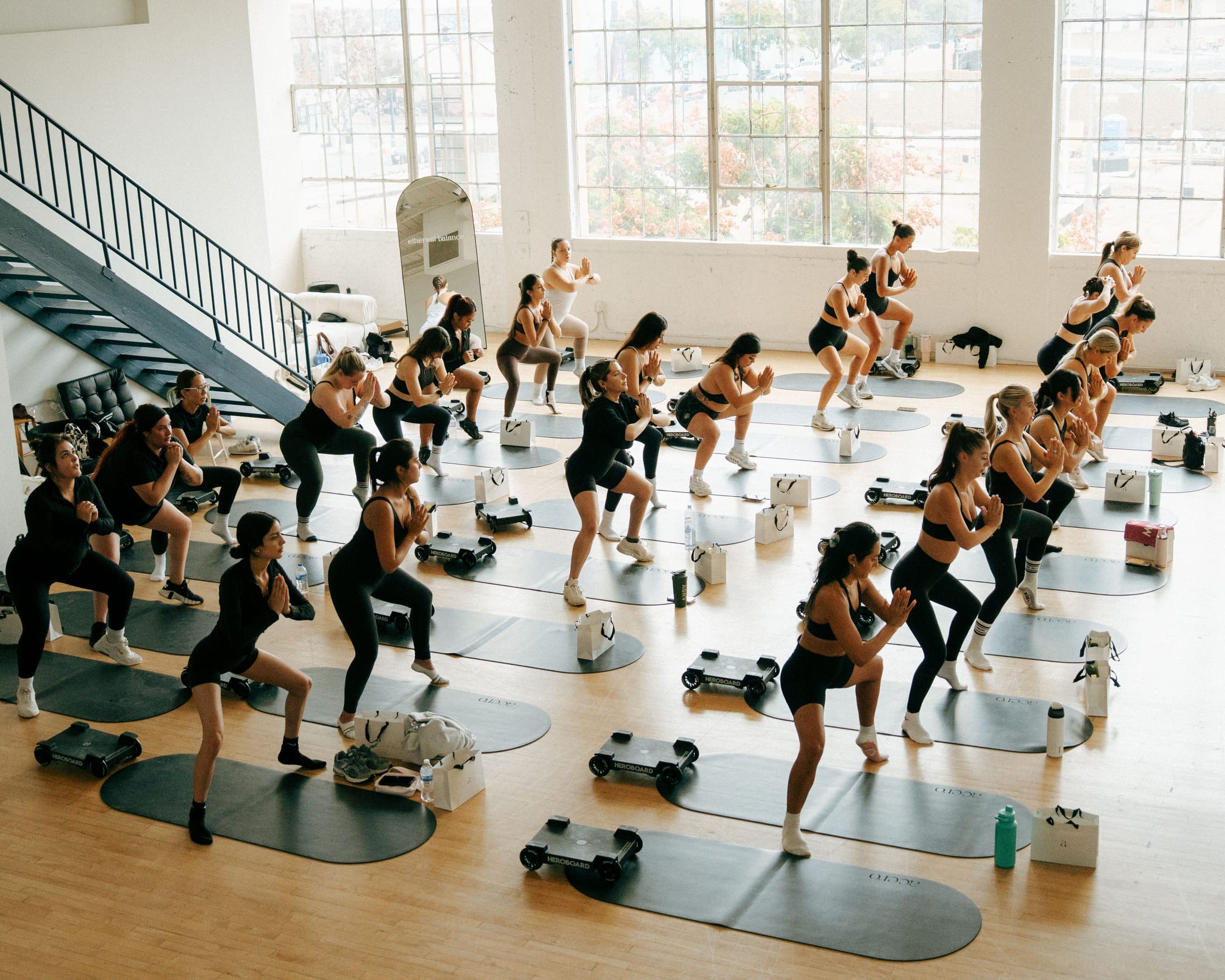 Corporate team in a guided Pilates wellness session